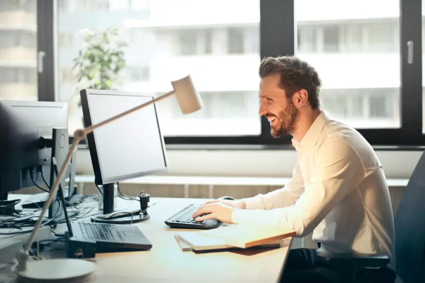 A happy man at the office desk