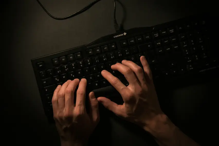 A person writing on a keyboard